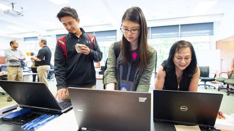 University of the Pacific students and a staff member use computers