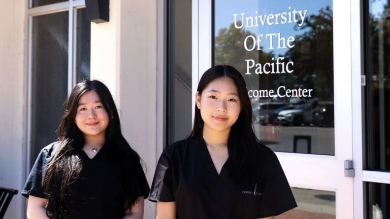 two pre-health students in front of burns tower