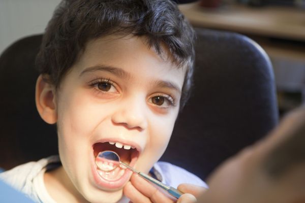 cute kid pointing to tooth