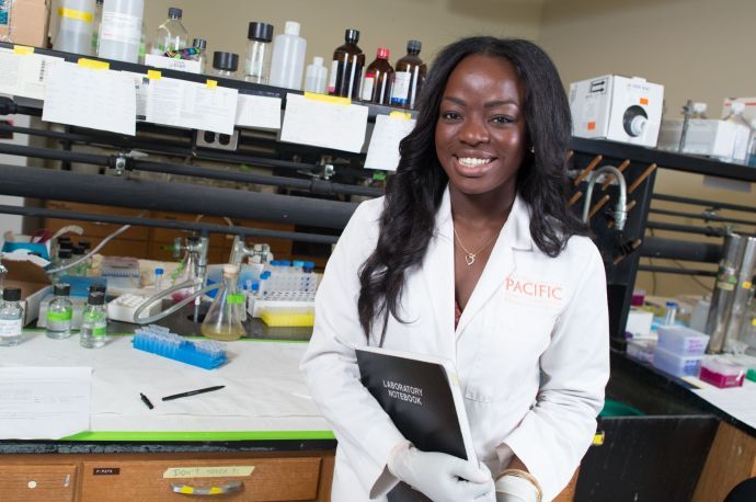 Student holding a lab notebook