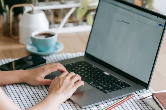 Unrecognizable person typing on laptop