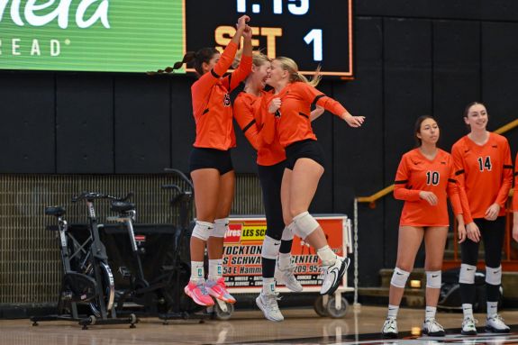 Volleyball team jumps in celebration