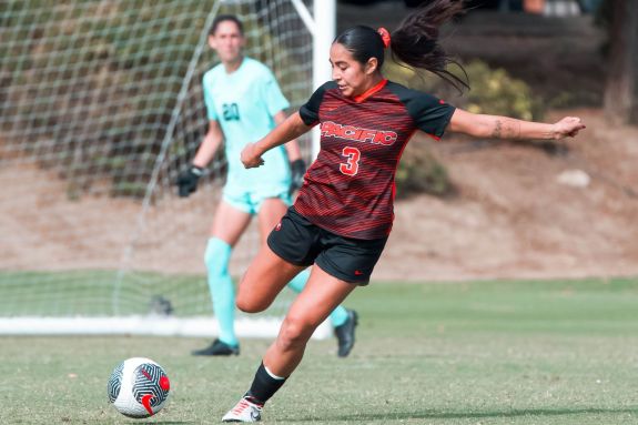 Soccer player shoots the ball.