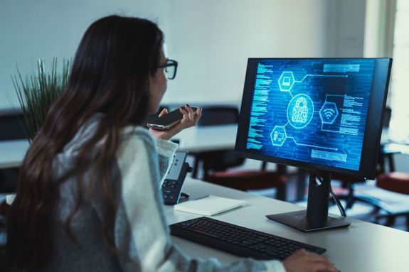 Cybersecurity student working on computer