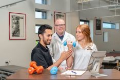 PT students and instructor using weights