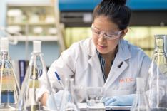 Student wearing lab coat in research lab