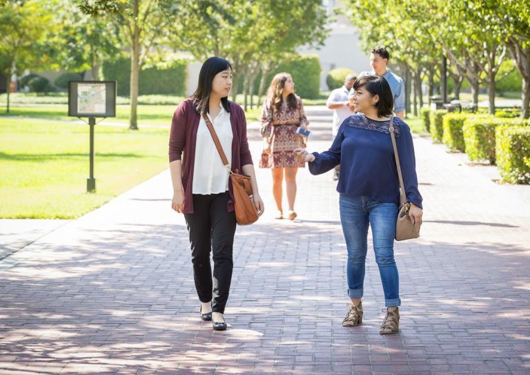 graduate students walk on campus