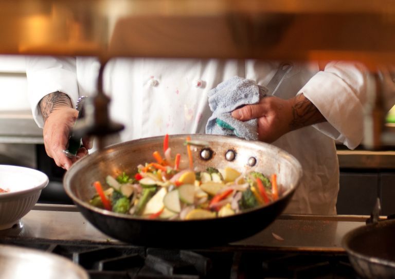 cook making stir fry