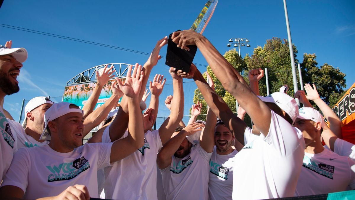 The water polo team celebrates their win after the game.