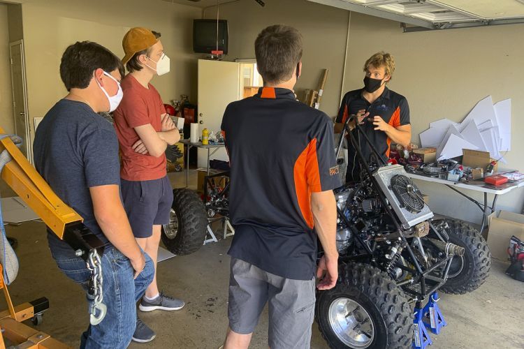 Students working on car