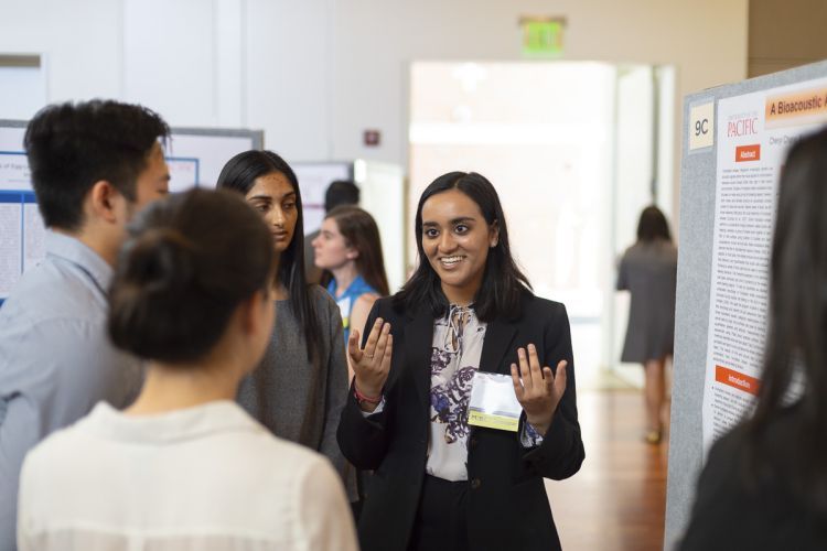 A student presents her research to other students