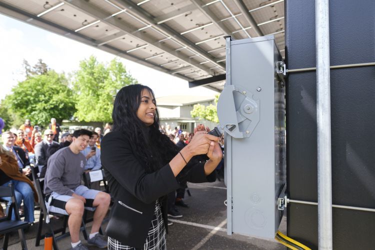 A student "flips the switch" for the solar panels