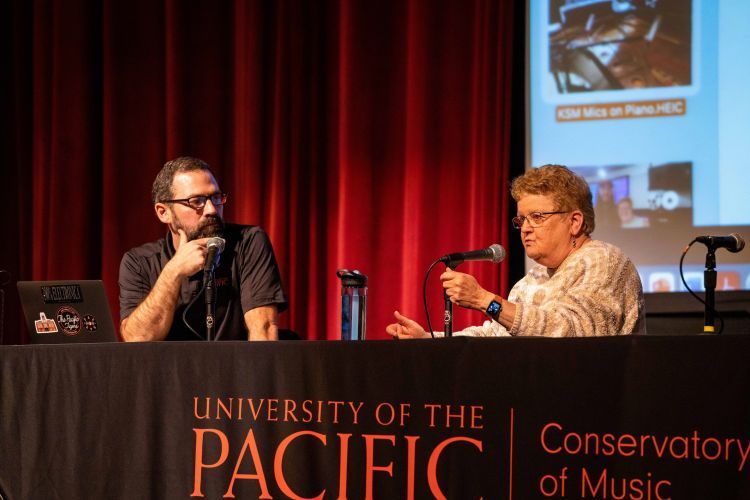 Benom Plumb and Leslie Ann Jones sit a table for a panel discussion