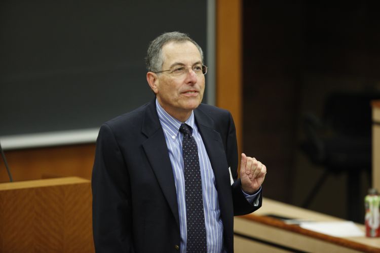 A photo of a man teaching in a classroom