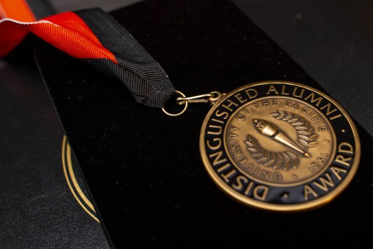 medal reading "Distinguished Alumni Award"