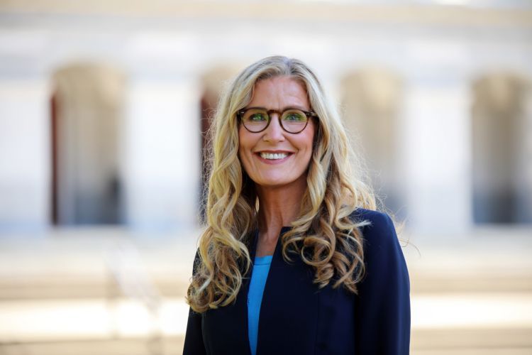 A portrait of a woman in front of the California Capitol Building