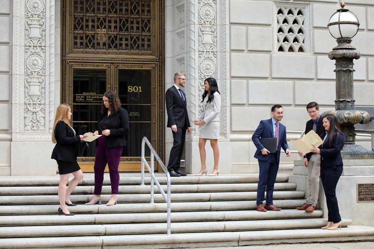 Law students stand on the steps of the Federal Defender’s Office