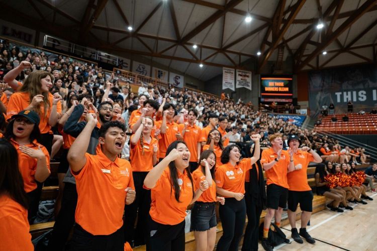 students cheer inside the Alex G. Spanos Center