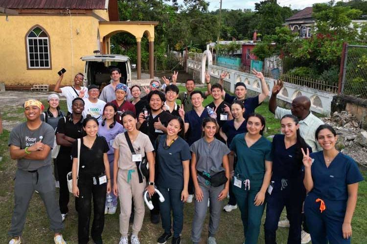 group of 30 people outside wearing scrubs in Jamaica