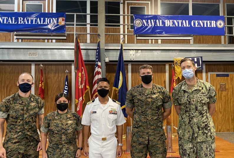 Left to Right: Lieutenant Adam Gluskin ’17, Commander Sherry Caraveo ’04, Captain Jerome Ragadio ’03, Lieutenant Michael Lawrence ’16 and Lieutenant Commander Eric Frederiksen ’11. (Not pictured: Lieutenant Commander Michael DeFazio ’13)