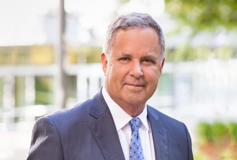 A close-up shot of a man in a suit and tie 