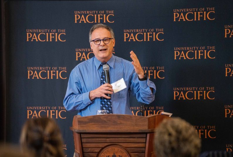 A professor standing at a podium