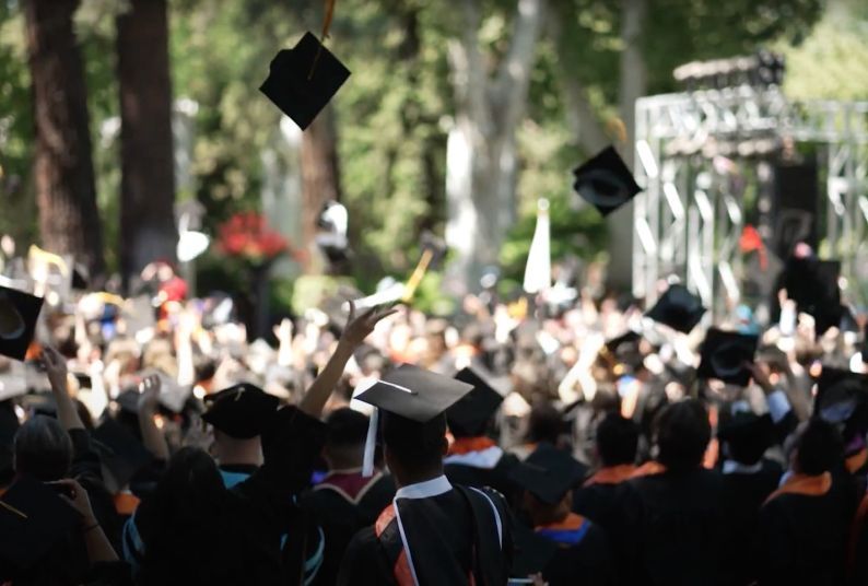 graduates throwing their caps in the air