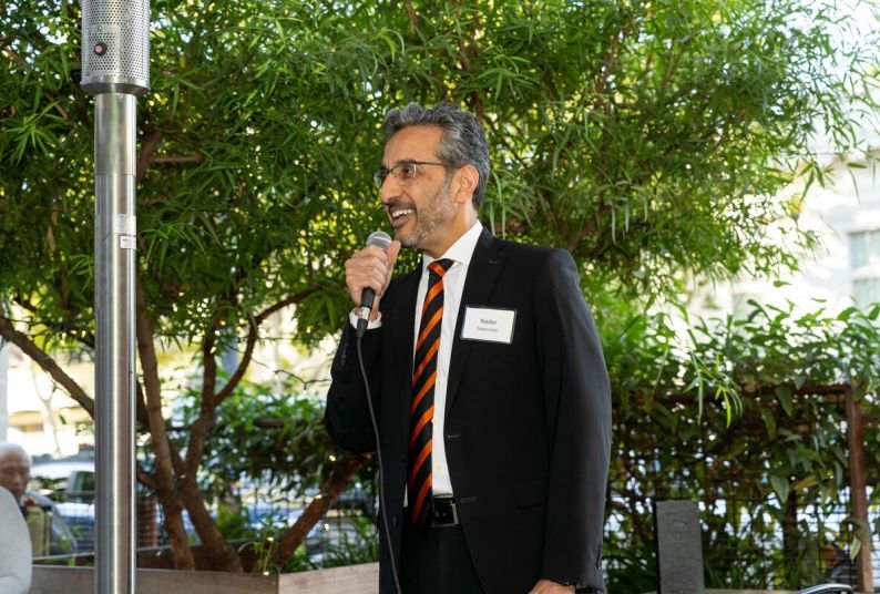 nader nadershahi speaks into a microphone