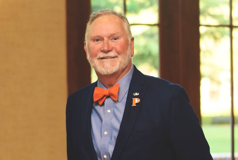 A portrait of a man in a suit and bowtie