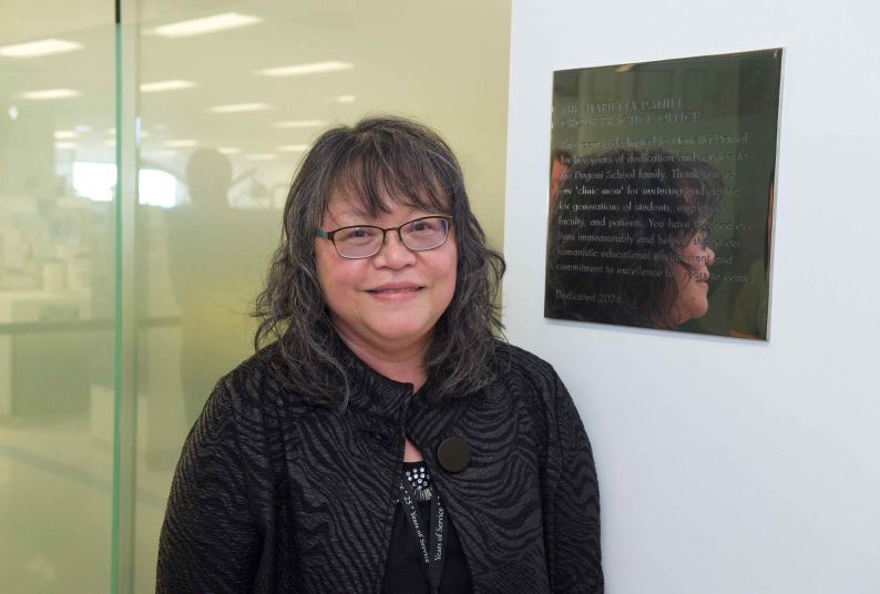 Marietta in front of her plaque