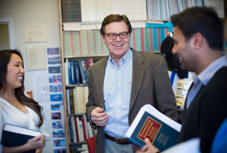 Stephen McCaffrey photographed smiling with law students.