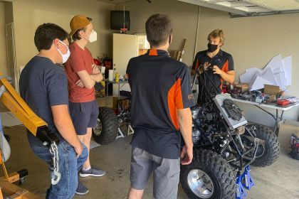 Students working on car