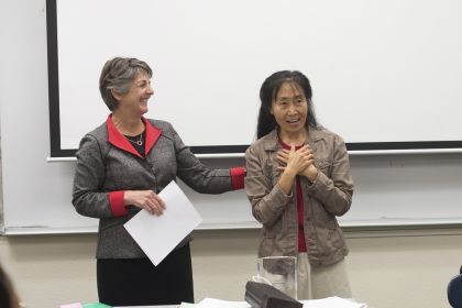 Provost Maria Pallavicini informing Professor Xiaojing Zhou that she had won the 2015 Distinguished Faculty Award.