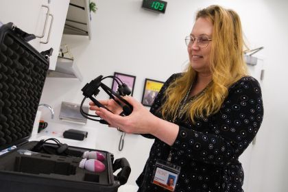 Gabriella Musacchia holds a headset used for audiology research