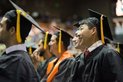 graduates attend a commencement ceremony