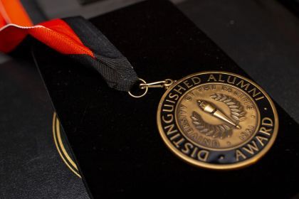 medal reading Distinguished Alumni Award