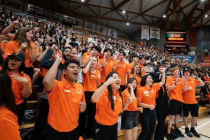 students cheer inside the Alex G. Spanos Center