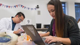 student in front of a laptop