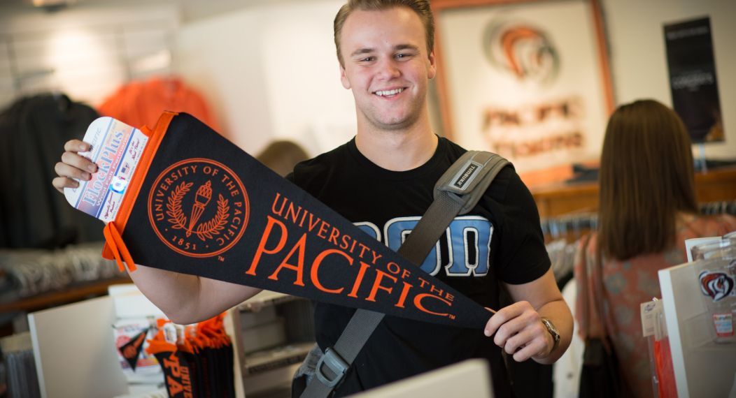 guy holding pennant 