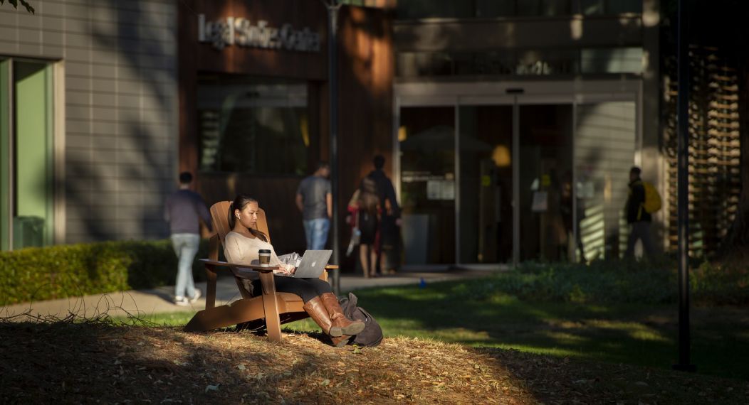 A law student warms in the winter sun on the McGeorge Law School lawn