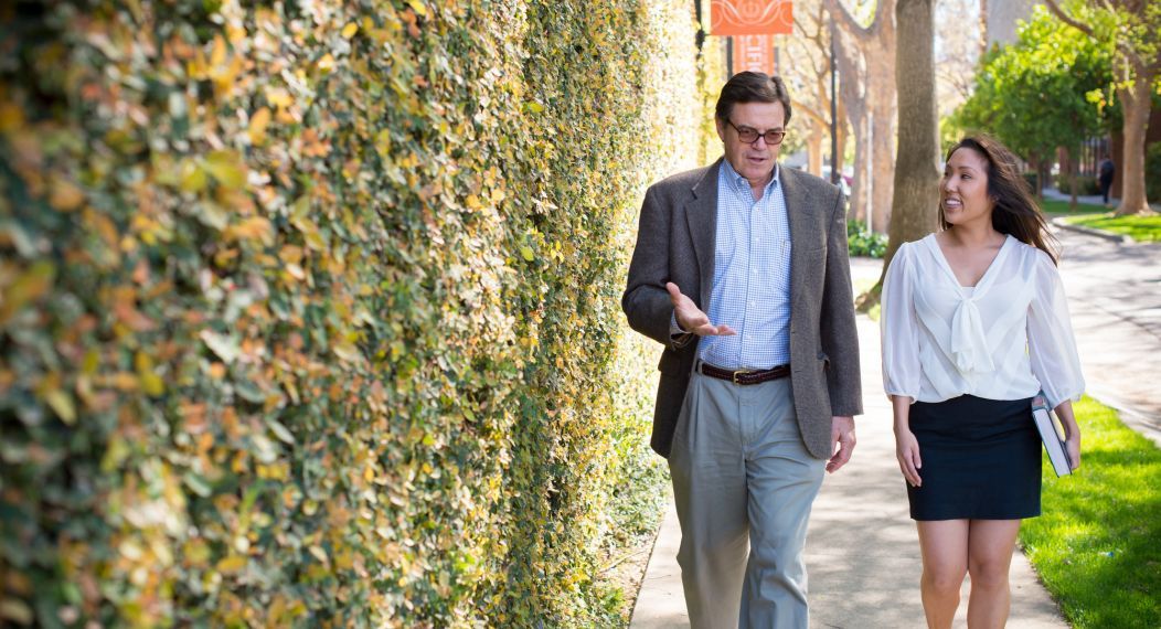 Professor McCaffery walking with a student