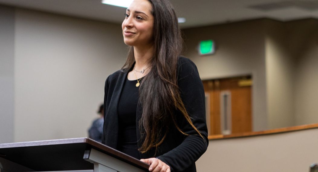 A female student at a podium