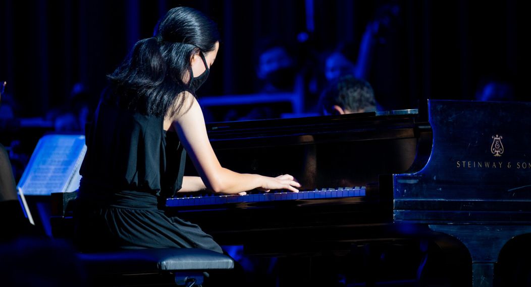 A Pacific student playing the piano