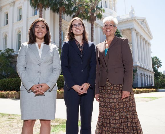 three students in front of the capitol