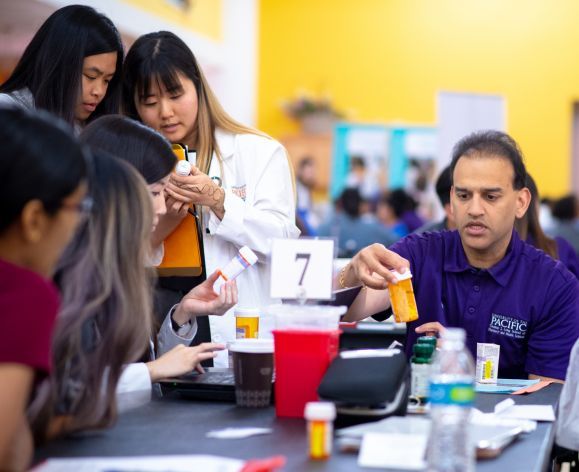 Raj Patel with PharmD students at Medicare Part D Outreach Clinic event