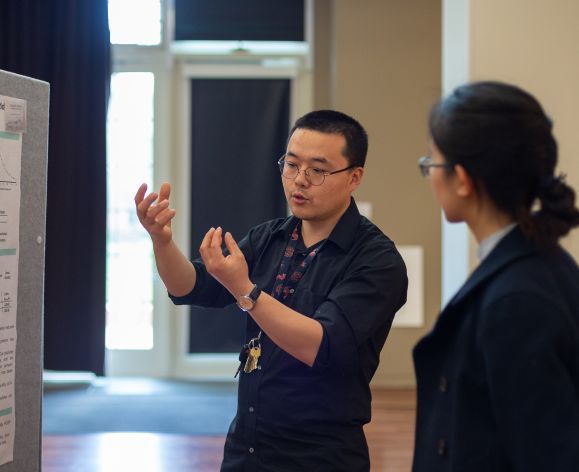 Student presenting a research poster