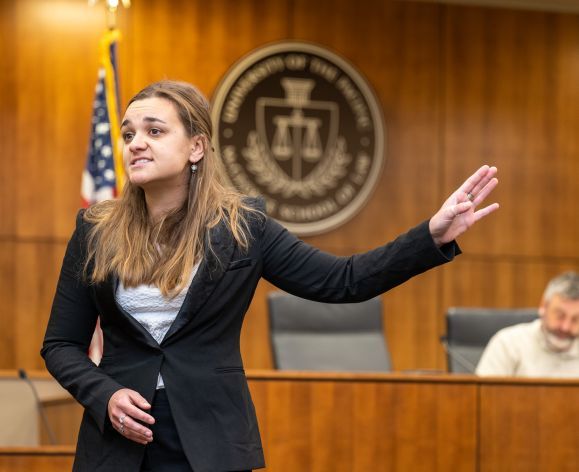 A law student gives a practice opening argument.