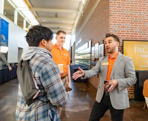 Representatives from the University of the Pacific Community Involvement Program speaks to a student